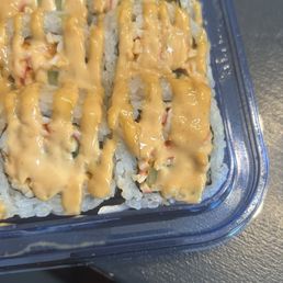 Sushi roll with thick black hair on it.