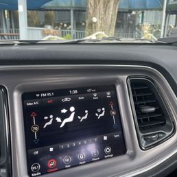 Photo of my car clock showing 1:37 while 2 closed signs hang on the doors.