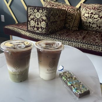 Raha Coffee House - Pistachio latte and signature latte with a mini Dubai chocolate bar - Coffee & Tea Near Me - Buffalo, New York Raha Coffee House - Pistachio latte and signature latte with a mini Dubai chocolate bar - Coffee & Tea Near Me - Buffalo, New York