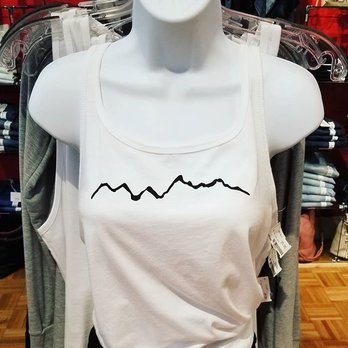 Accentuate - Bring the Grand Tetons home with you on one of our locally printed tops! - Women's Clothing Near Me - Jackson, Wyoming Accentuate - Bring the Grand Tetons home with you on one of our locally printed tops! - Women's Clothing Near Me - Jackson, Wyoming