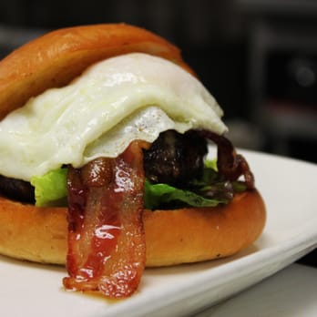 District Tavern - District Tavern Breakfast Burger includes a fried egg your way, bacon, american cheese on a toasted brioche bun - Bars Near Me - Tampa, Florida