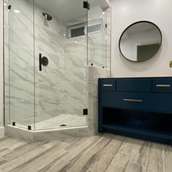 Urban Element - The natural look of porcelain tile gives this walk in shower depth and character.