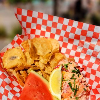 The Twisted Fig - a basket of food with chips and a slice of watermelon - Salad Near Me - Caldwell, Idaho