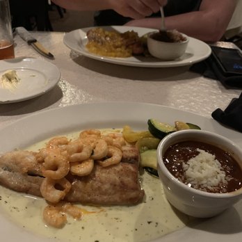 French Quarter Grille - Fresh redfish in a creamy brandy sauce topped with shrimp I added. Boyfriend had pork tenderloin - American Near Me - Austin, Texas French Quarter Grille - Fresh redfish in a creamy brandy sauce topped with shrimp I added. Boyfriend had pork tenderloin - American Near Me - Austin, Texas