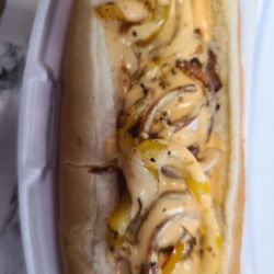 Twice Baked - Bacon Dog - All beef Hot dog wrap with bacon - topped with sauteed onions, peppers, & special sauce