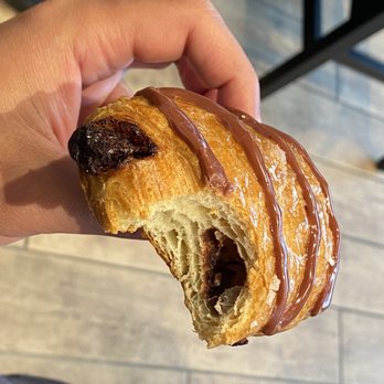 Tim Hortons - a hand holding a pastry with a bite taken out of it - Coffee & Tea Near Me - Sherwood Park, Alberta Tim Hortons - a hand holding a pastry with a bite taken out of it - Coffee & Tea Near Me - Sherwood Park, Alberta
