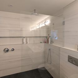 Grandmaster's Glass & Mirrors - Frameless glass shower installation featuring  1/2" clear tempered glass with polished edges.