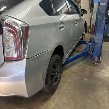Rancho Smog and Auto Repair - Toyota Prius being raised by the shop lift. - Auto Repair Near Me - Temecula, California Rancho Smog and Auto Repair - Toyota Prius being raised by the shop lift. - Auto Repair Near Me - Temecula, California