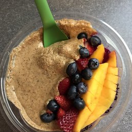 Pitaya bowl with mango, seasonal berries, granola, and almond butter