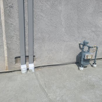 Dg Construction - Brought rain gutters into underground drains to prevent standing water on concrete. - General Contractors Near Me