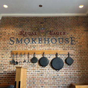 Regal Eagle Smokehouse: Craft Drafts & Barbecue - a brick wall with pans hanging on it - Barbeque Near Me - Lake Buena Vista, Florida