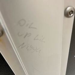 Idea Judson - A Stall that says "oil up lil n-word".