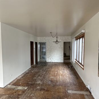 Sea Breeze Building Services - Living room before - Drywall Installation & Repair Near Me