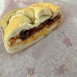 Werner's Deli - Half-eaten bacon & fried eggs on a roll.