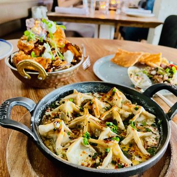 Byblos - a skillet of food on a wooden table - Mediterranean Near Me - Toronto, Ontario