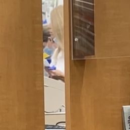 a woman sitting at a desk in a library