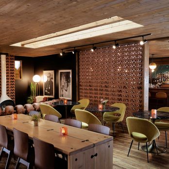 A Frame Club - a long table with chairs and a bar in the background - Hotels Near Me - Winter Park, Colorado