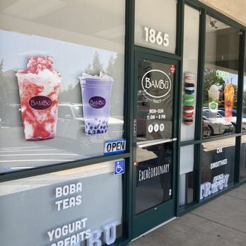 BAMBU - Front of store - BAMBU in Tracy, CA, has a storefront with large windows displaying images of bubble tea and macarons, with business hours and signage. - Bubble Tea Near Me - Tracy, California