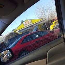 Alpha Auto Repair - Small yellow house like building in between trailer park and homes