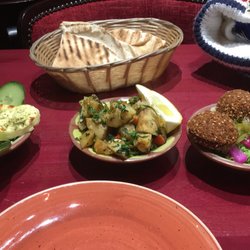 Houlummi cheese, patata harra, and falafel (l to r), pita bread in background.