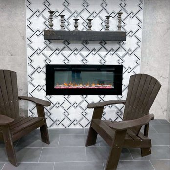 Ronie Construction - two adisson chairs in front of a fireplace - General Contractors Near Me - Malden, Massachusetts Ronie Construction - two adisson chairs in front of a fireplace - General Contractors Near Me - Malden, Massachusetts