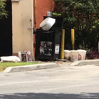 China Brothers Restaurant - a trash can and trash cans on the side of the road - Chinese Near Me - Orlando, Florida
