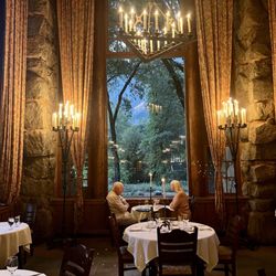 The Ahwahnee - Dining room with huge windows and tall candles on each table