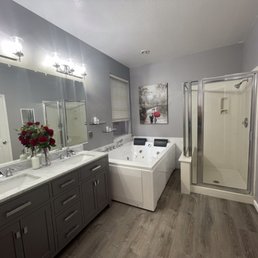 Master Bathroom - whirlpool tub, solid wood vanity & marbled backsplash. Luxury Vinyl flooring installed by Alan and his crew