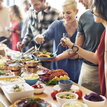 Huge Table Catering - a group of people serving food - Buffets Near Me Huge Table Catering - a group of people serving food - Buffets Near Me