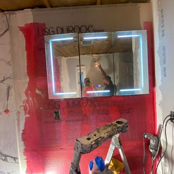 CH General Construction - a man painting a wall - General Contractors Near Me