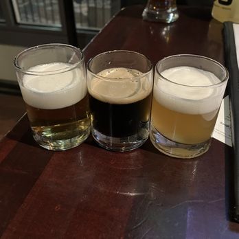 The Tap - L to R: White Mocha Stout, Winter Staycation, Weihenstephaner Hefeweissbier - Bars Near Me - Bloomington, Indiana
