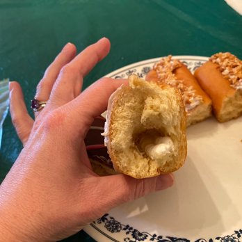 McHappy's Bake Shoppes - a hand holding a half eaten doughnut - Bakeries Near Me - Marietta, Ohio McHappy's Bake Shoppes - a hand holding a half eaten doughnut - Bakeries Near Me - Marietta, Ohio