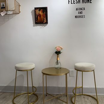 Small Format - two stools and a table with a vase of flowers on it - Coffee & Tea Near Me - Providence, Rhode Island