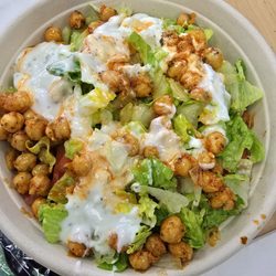 Hummus Mediterranean - RICE Bowl with bulgur, chicken shish kabob, lettuce, chickpeas, white sauce. Looks great.