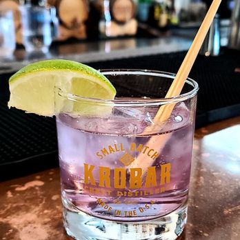 The Hub - a purple drink with a lime wedge - Distilleries Near Me - San Luis Obispo, California