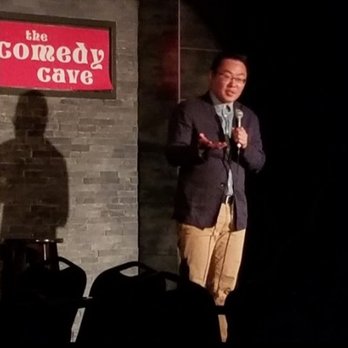 The Comedy Cave - a man speaking into a microphone - Comedy Clubs Near Me - Calgary, Alberta The Comedy Cave - a man speaking into a microphone - Comedy Clubs Near Me - Calgary, Alberta