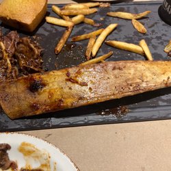 Montana's - honkin big bone.... allot of fat leftover it's at the left side of the photo.