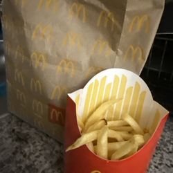 McDonald's - My medium fry they charge $4 for .. I haven't event ate one yet and no there are none in the bottom of the bag !!