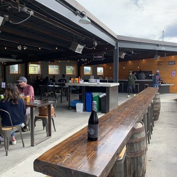 Structures Brewing - Back patio and bar with a delicious bottle purchase - Brewpubs Near Me - Bellingham, Washington