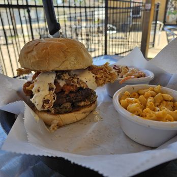 Grubeez - Curd burger is awesome. Crispy chicken fried bacon! Amazing! Cheese curds on a burger! Amazing! Spicy pickles! Amazing! - A fried chicken sandwich with cheese curds and macaroni and cheese served outdoors at a restaurant. - American Near Me - Davenport, Iowa