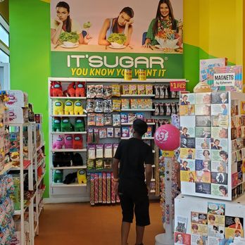 IT'SUGAR - a woman shopping in a store - Candy Stores Near Me - Brooklyn, New York