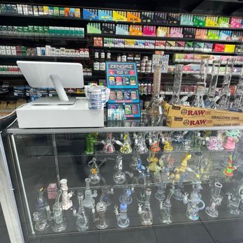 Smoke Nest - a glass display case with a variety of smoking accessories - Tobacco Shops Near Me - Long Beach, California
