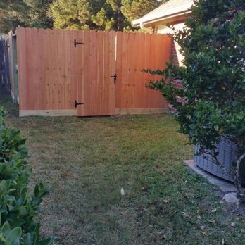 Raintite Gutters & Construction - a backyard with a wooden fence - General Contractors Near Me - Katy, Texas