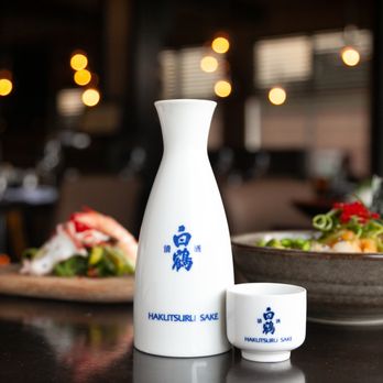 Satori Sushi - a sake bottle and a cup on a table - Sushi Bars Near Me - Saint-Jean-sur-Richelieu, Quebec Satori Sushi - a sake bottle and a cup on a table - Sushi Bars Near Me - Saint-Jean-sur-Richelieu, Quebec