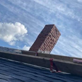 BMW Construction - a brick chimney on the roof of a house - General Contractors Near Me