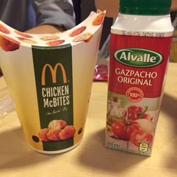 Chicken bites and gazpacho in a bottle