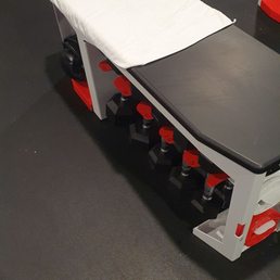 The dumbbells and brass knuckles are under the bench.