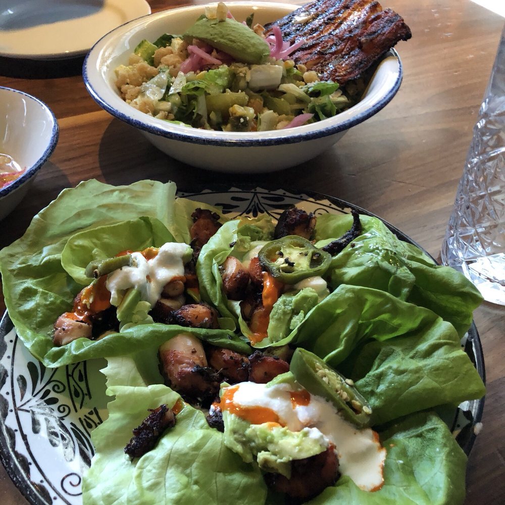 Barrio - Octopus tacos on bibb lettuce in the front, chopped salad with mahi in the back - Mexican Near Me - Chicago, Illinois Barrio - Octopus tacos on bibb lettuce in the front, chopped salad with mahi in the back - Mexican Near Me - Chicago, Illinois