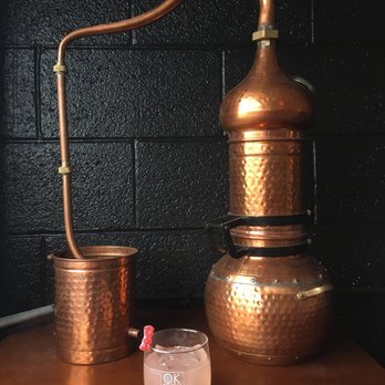 Oklahoma Distilling - a copper pot and a glass - Distilleries Near Me - Tulsa, Oklahoma