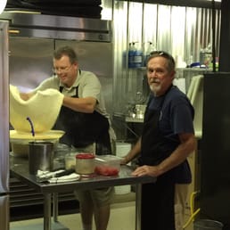 The pro teaching an apprentice the secrets of his delicious crusts. The pro teaching an apprentice the secrets of his delicious crusts.